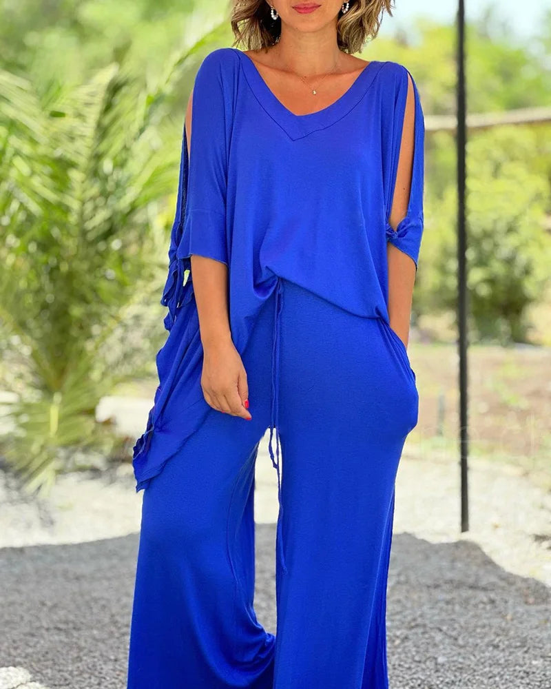 Laisvas dviejų dalių kostiumas plačiomis klešnėmis